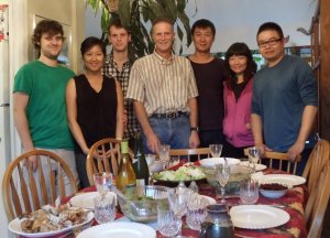 Some of the family, and some of the mentees, posing with the Thanksgiving turkey & stuffing.